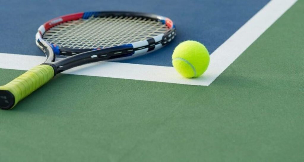 tennis racket and tennis ball on the floor 