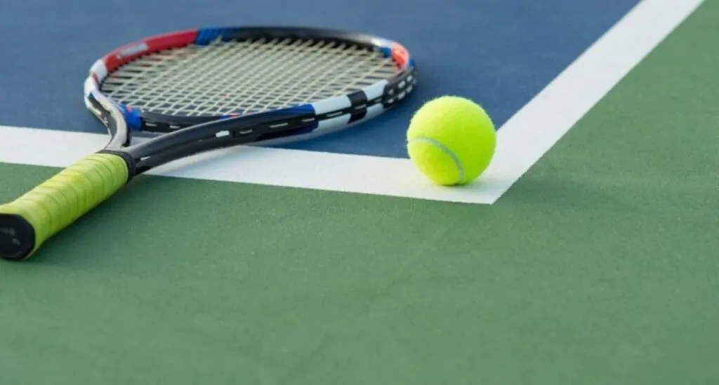 tennis racket and tennis ball on the floor